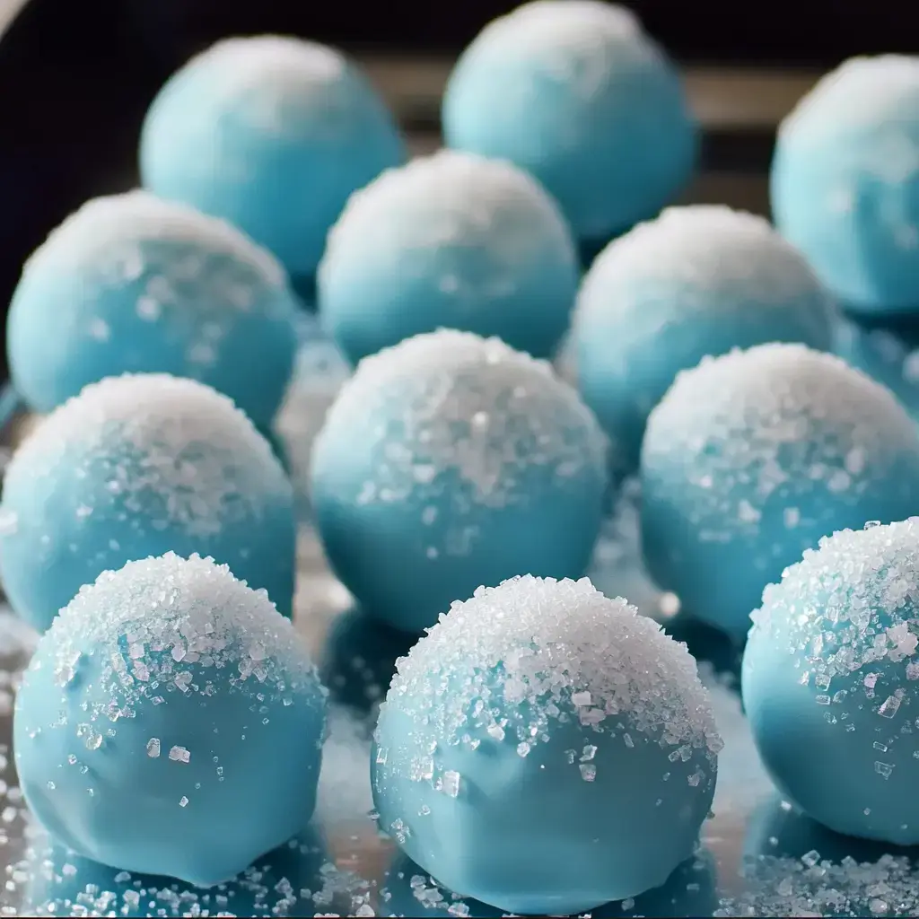 A plate of sugar-coated blue dessert balls shining brightly.