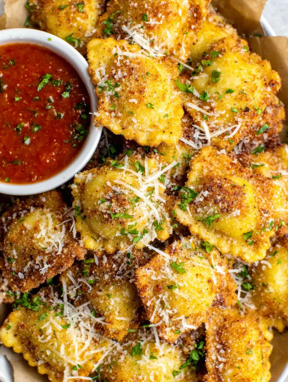 A bowl of fried ravioli with cheese.