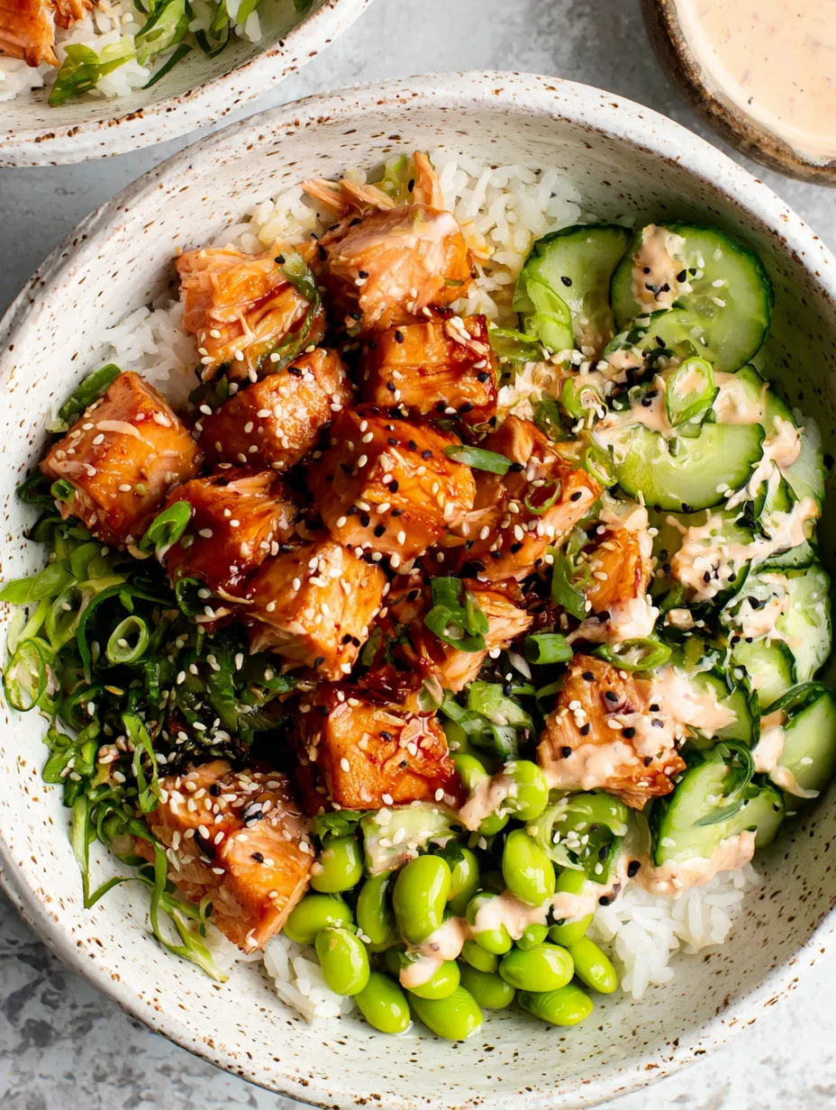 A bowl of food with rice, meat, and vegetables.